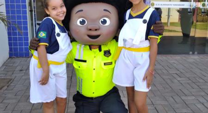 Crianças se divertem com a mascote da Campanha Maio Amarelo
